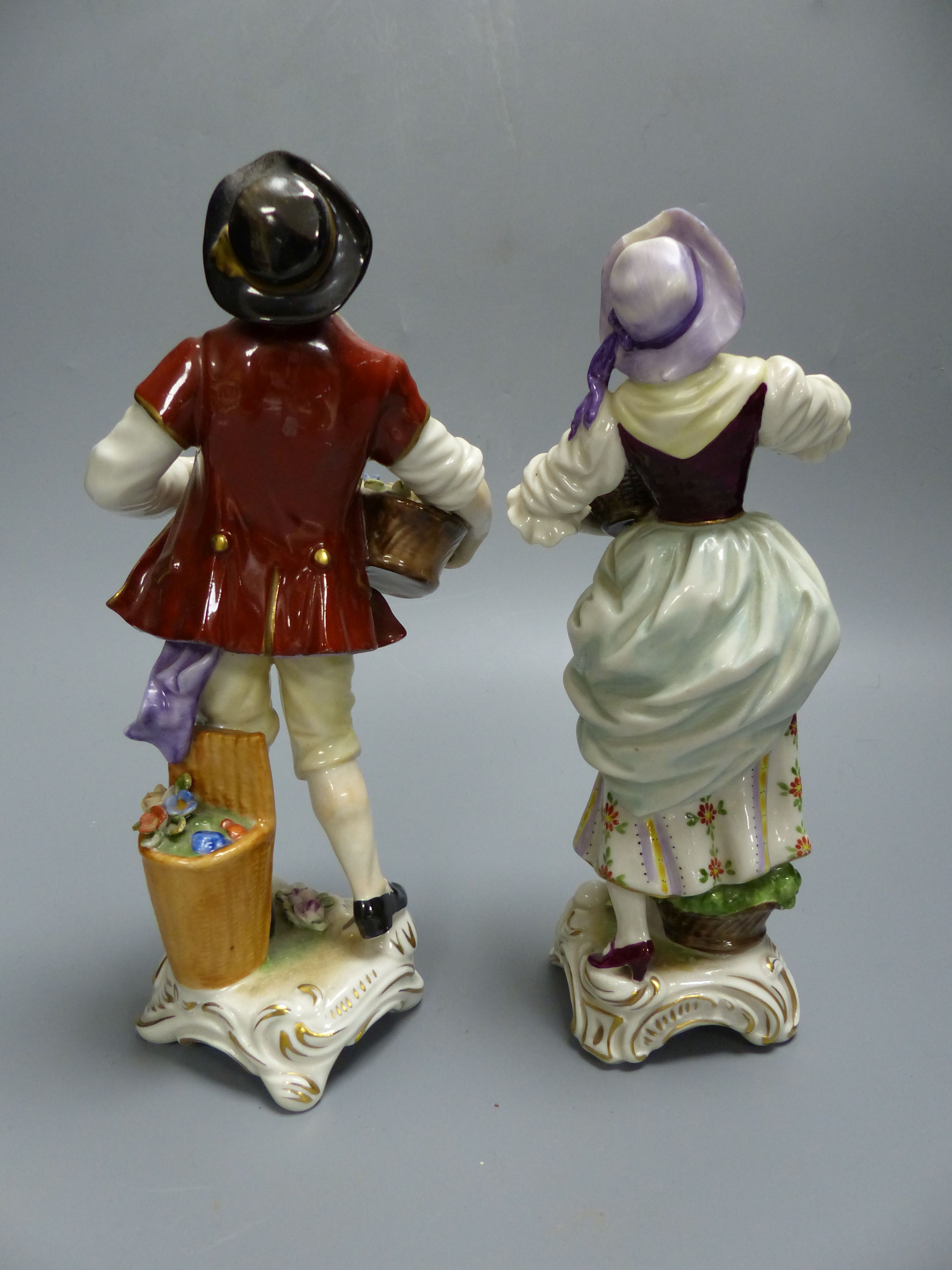 A pair of Rudolf Kammer porcelain figures of flower carriers, height 23cm